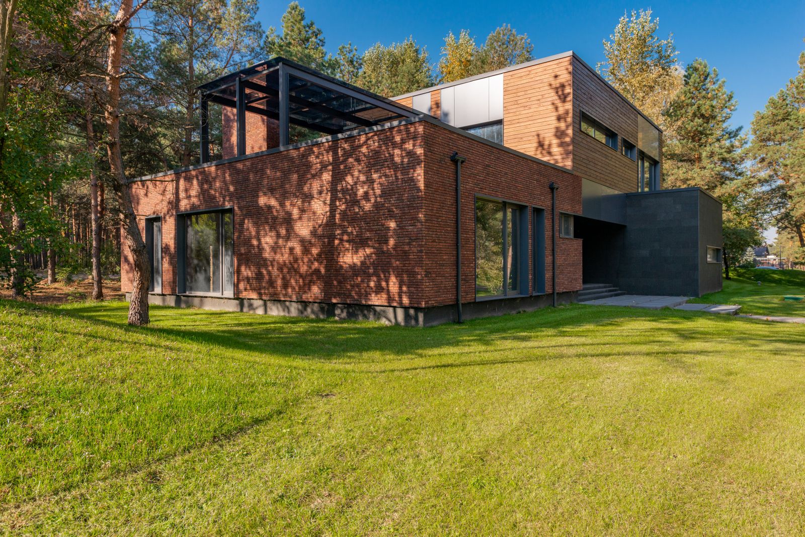 Contemporary brick and timber house in a landscaped garden